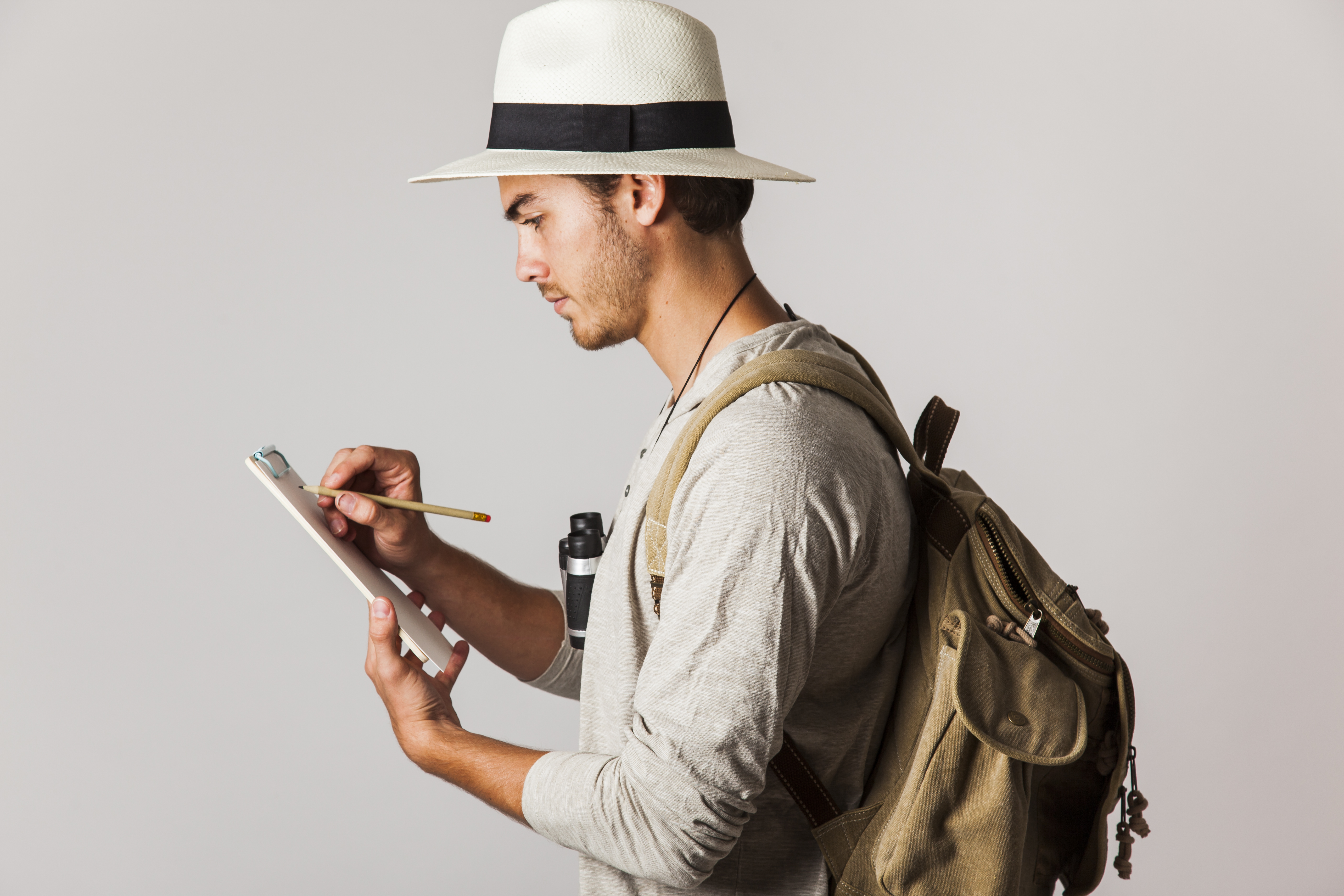 hipster-style-tourist-writing-clipboard